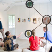 Paul Bright, assistant director of the Charlotte and Philip Hanes Art Gallery, leads a critique during his summer-session course on collage at the Student Art Gallery in Reynolda Village.