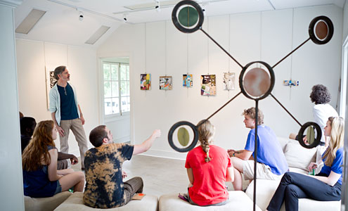 Paul Bright, assistant director of the Charlotte and Philip Hanes Art Gallery, leads a critique during his summer-session course on collage at the Student Art Gallery in Reynolda Village.
