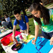 First-year student Keirah Carmichael (right) paints a shirt to hang on the clothesline.