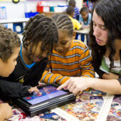 Wake Forest senior Kaela MacPhail ('11) teaches a lesson using iPad tablet computers in a kindergarten class at Ashley Elementary School in Winston-Salem, N.C.