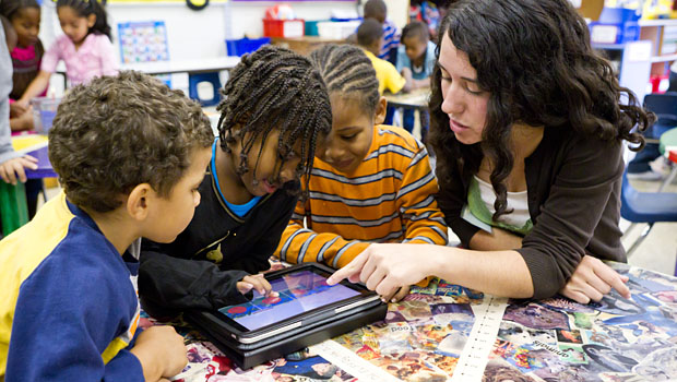 Wake Forest senior Kaela MacPhail ('11) teaches a lesson using iPad tablet computers in a kindergarten class at Ashley Elementary School in Winston-Salem, N.C.