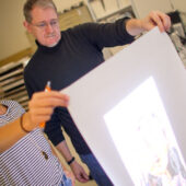 Assoc. Prof. John Pickel helps a student with her video art project.