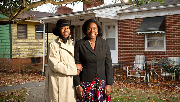 Law student Ashleigh Wilson ('11), right, stands with homeowner Tonya Williams.