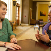 Senior Rebecca Hinson, at left, interviews academic advisor Tiffany Waddell for her Wake at Work oral history project.