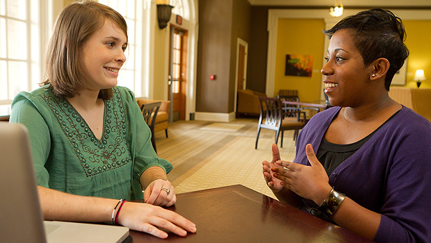 Senior Rebecca Hinson, at left, interviews academic advisor Tiffany Waddell for her Wake at Work oral history project.