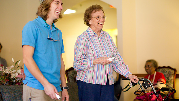 Sophomore Michael Scott competes against resident Joan Stewart in Wii Bowling at Independence Village, a retirement community in Winston-Salem.