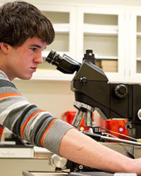 physics student using a microscope