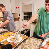 Campus Kitchen student volunteers delivered Thanksgiving dinner to the Children's Home in Winston-Salem in 2010. Sophomores Brad Shugoll (right) and Chris Iskander prepare and serve.