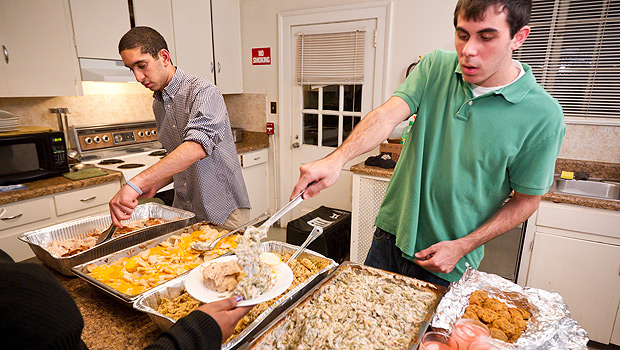 Campus Kitchen student volunteers delivered Thanksgiving dinner to the Children's Home in Winston-Salem in 2010. Sophomores Brad Shugoll (right) and Chris Iskander prepare and serve.