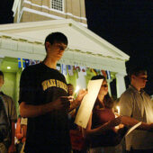 Student holding candles in front of Wait Chapel