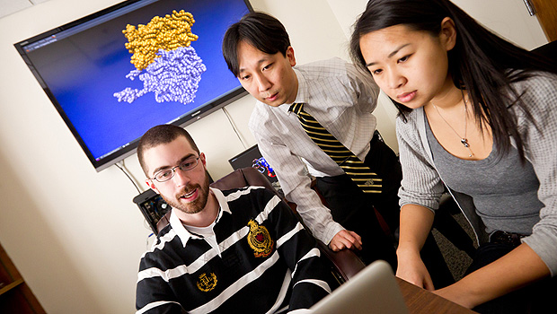 Computer science and physics professor Samuel Cho (center) works with his students, graduate student Tyson Lipscomb (left) and senior Anqi Zou ('12).