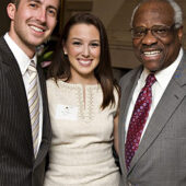 Marc Rigsby ('13) and Shay Miller ('13) pose with U.S. Supreme Court Justice Clarence Thomas.