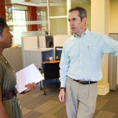 Patrick Sullivan (right), the assistant director of career education and counseling, talks with a student in the OPCD office.