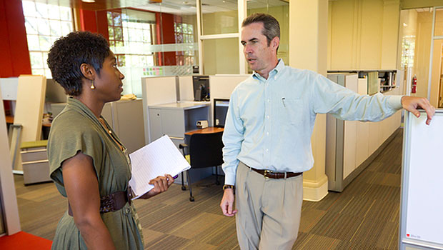 Patrick Sullivan (right), the assistant director of career education and counseling, talks with a student in the OPCD office.