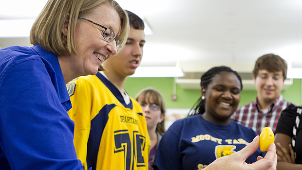 Gloria Muday works with local students.