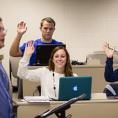 Accountancy graduate student Tori Stewart (front left, '12, MSA '13) interacts in her business ethics class taught by professor Matthew Phillips.