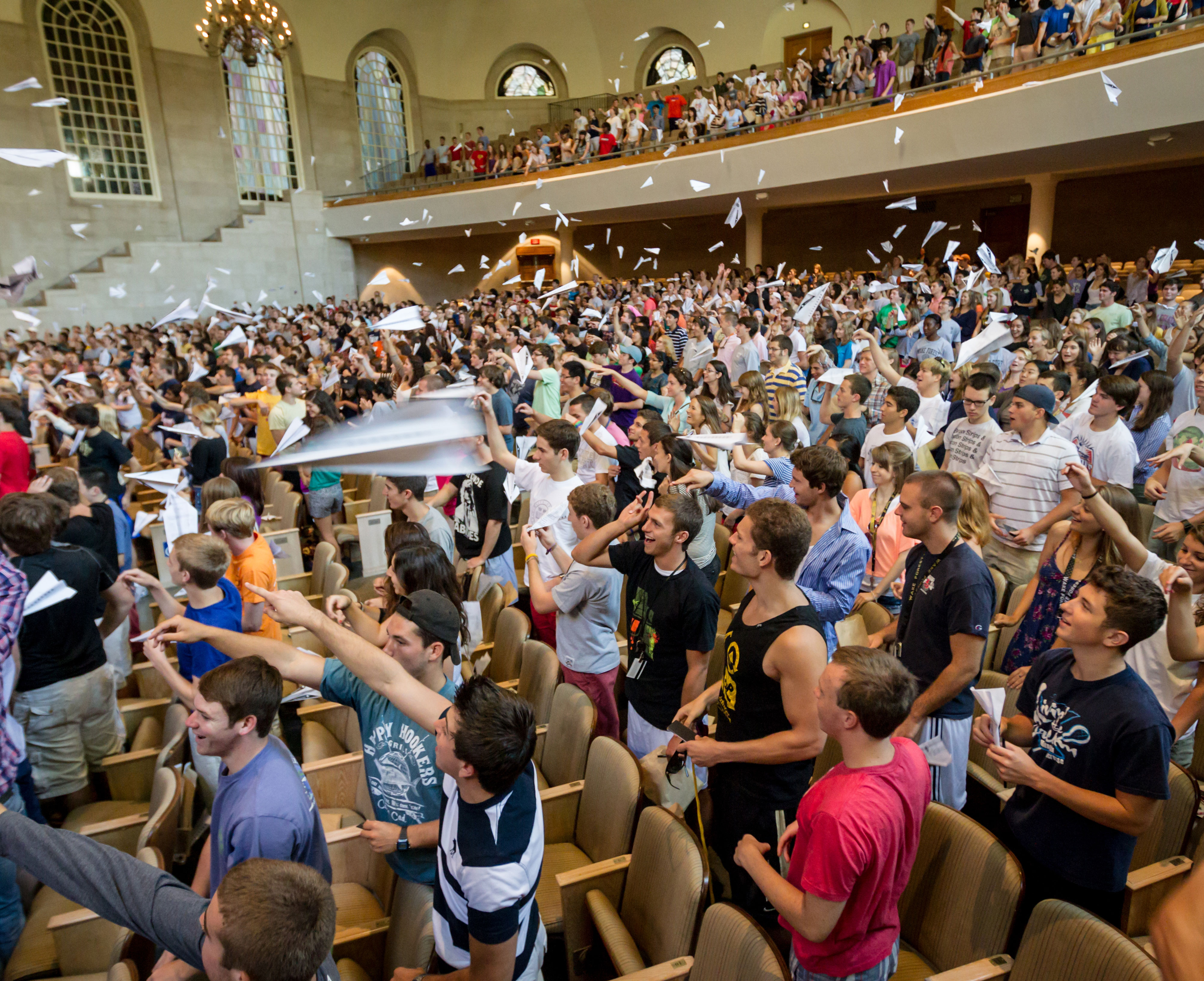 Students throwing paper airplanes in Wait Chapel