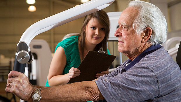 Lindsay Tise, 94, does strength-training exercises under the supervision of Sarah Commander ('14).