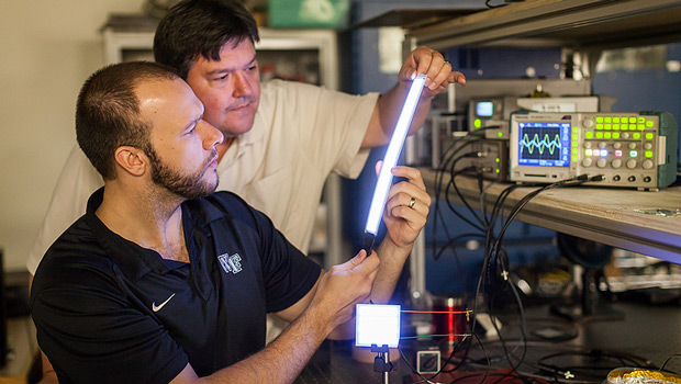 Professor David Carroll works with graduate student Greg Smith on the new lighting technology, FIPEL.