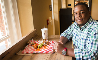 Thomas Ray, coordinator for outdoor programming initiatives, enjoys his lunch break at Zick’s.