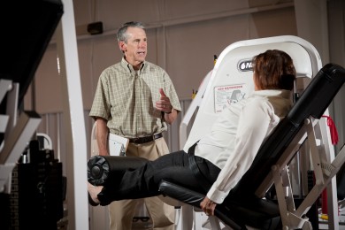 Professor Steve Messier talks with START participant Kay Sages at the exercise research facility on Thursday, July 12, 2012. 