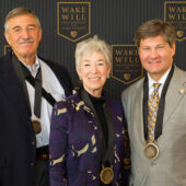 Mike (l) and Debbie (c) Rubin and Bobby Burchfield (r) attend a luncheon in their honor.