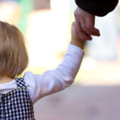 Daughter holding father's hand