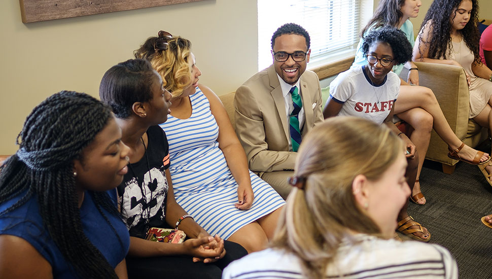 Students talk with Dr. J in the newly renovated Intercultural Center.