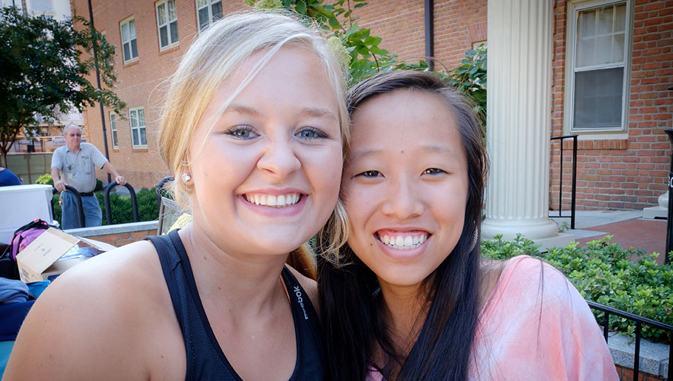 Nicole Rogers (left) meets up with her friend Celia Zhou on move-in day.