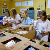 Students pack food at a food pantry