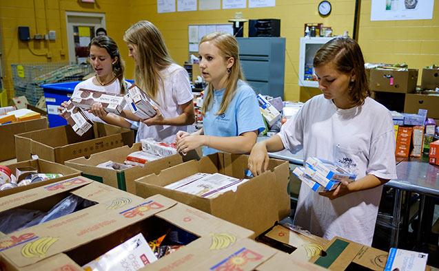 Students pack food at a food pantry