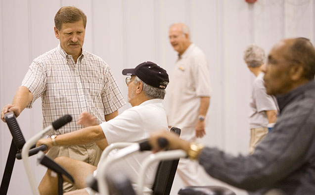 Professor of Health and Exercise Science researcher Jack Rejeski talks with research subjects.