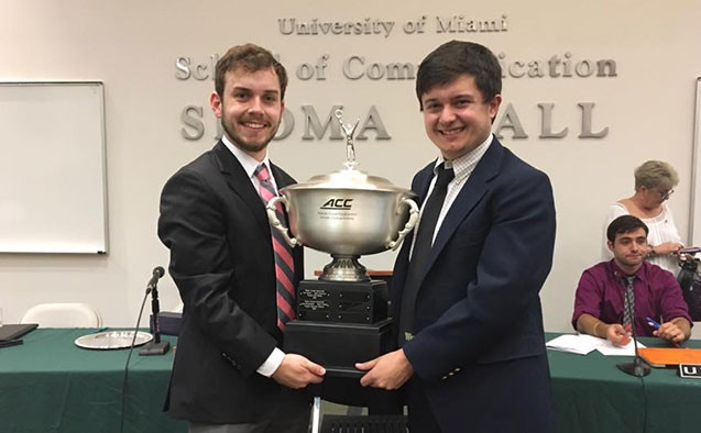 Wake debaters holding ACC trophy