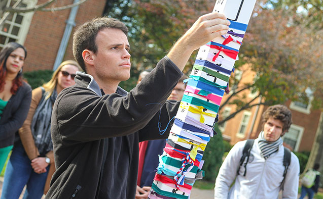 Wake Forest students participate in a prayer walk and tying torn ribbon around a peace pole following terror attacks in France.