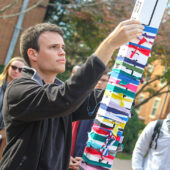 Wake Forest students participate in a prayer walk and tying torn ribbon around a peace pole following terror attacks in France.