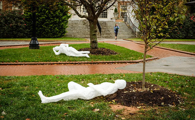 ​Tape cast 'people' travel around campus in 'flat Stanley'-style, sitting at picnic tables, under trees or on benches