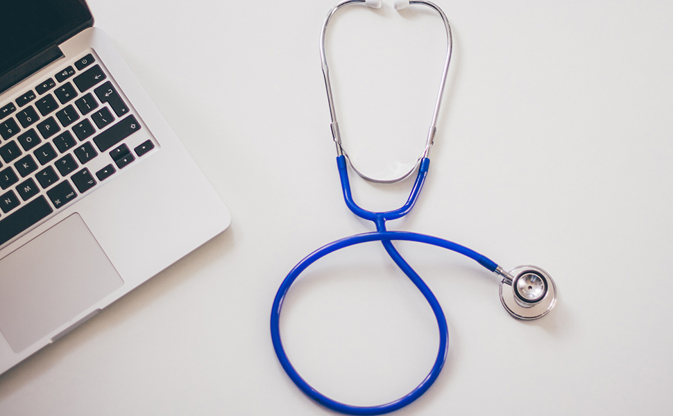 Stock image of a stethoscope and laptop.