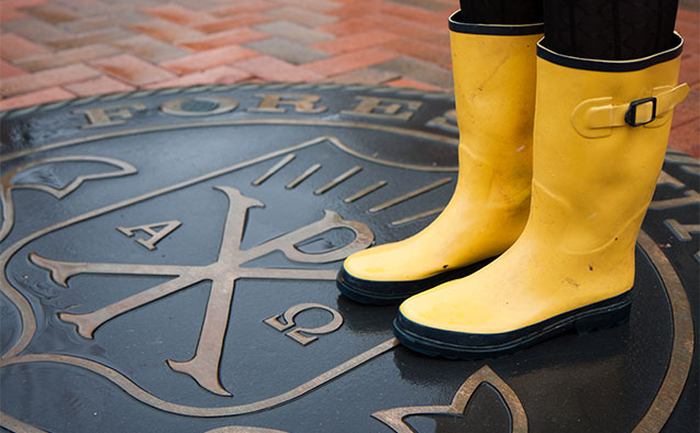 A student at Wake Forest wears rain boots on Hearn Plaza.