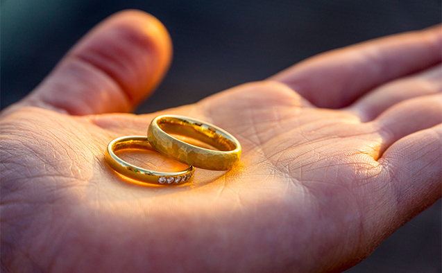 Hand holding golden rings