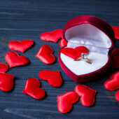 Red heart-shaped box with a ring in it