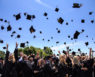 Students toss their caps in the air at commencement