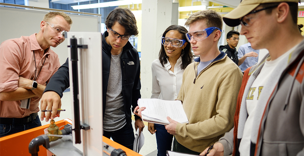 WFU engineering professor Lauren Lowman (middle) answers questions from a lab group.