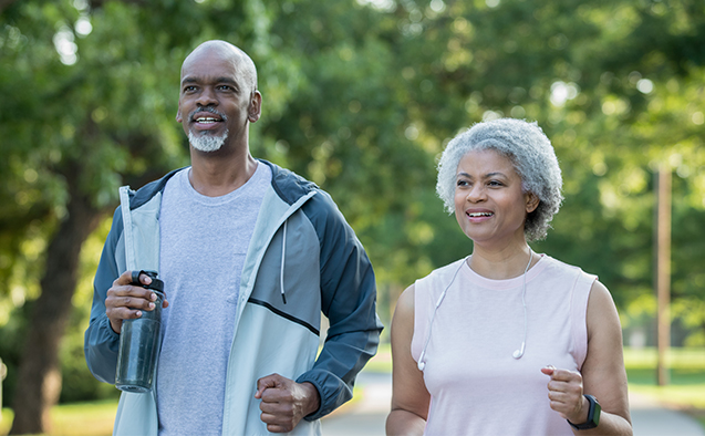 Active senior couple jogging outdoors together
