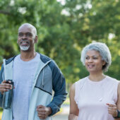 Active senior couple jogging outdoors together