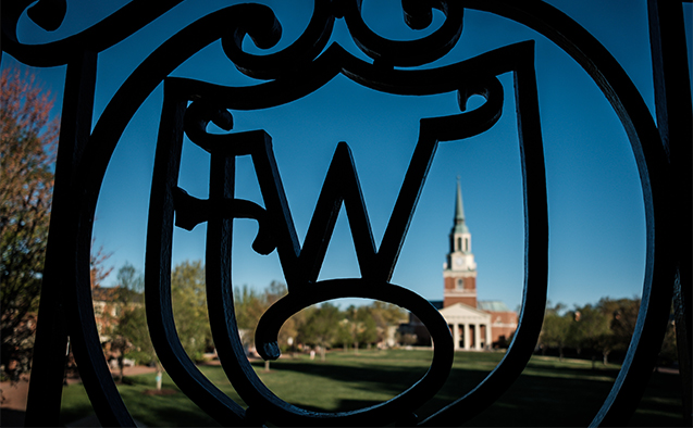 The WF ironwork on Reynolda Hall frames Wait Chapel in the early morning light, on the campus of Wake Forest University on Wednesday, April 10, 2019.