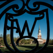 The WF ironwork on Reynolda Hall frames Wait Chapel in the early morning light, on the campus of Wake Forest University on Wednesday, April 10, 2019.