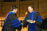 Ajay Patel, left, receives the Kienzle Teaching Award from Dean Charles Moyer