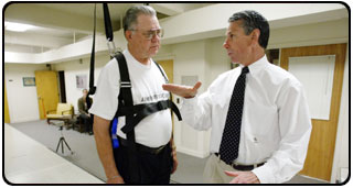 Steve Messier, right, works with a GATES participant in the J.B. Snow Biomechanics Lab.