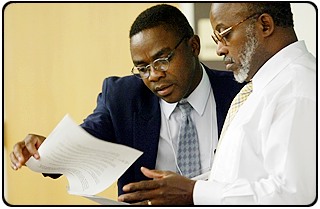 Sylvain Boko, left, talks with sociology professor Earl Smith at a campus symposium on African development.