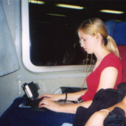 Alyssa Biber uses her hand-held computer to record data for her education class while traveling on the train in Europe.
